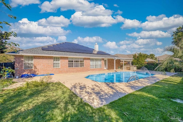 view of swimming pool featuring a yard and a patio