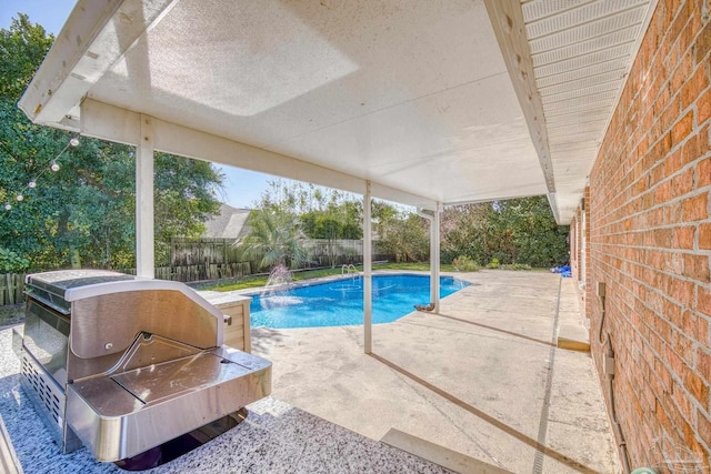 view of pool with pool water feature and a patio area