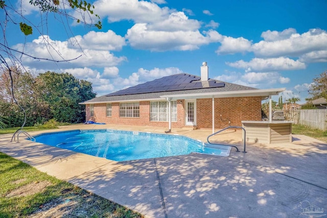 view of swimming pool featuring exterior bar and a patio