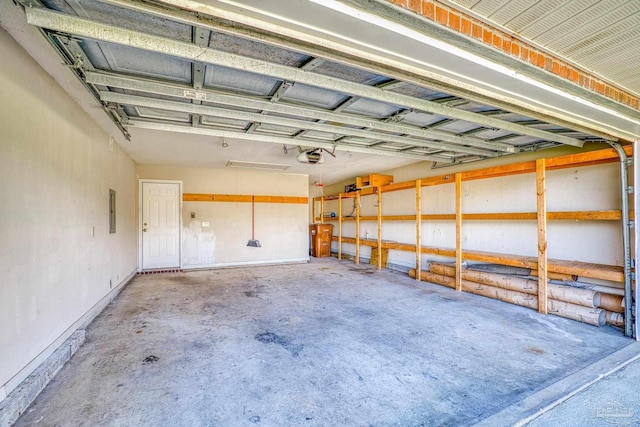 garage with electric panel and a garage door opener