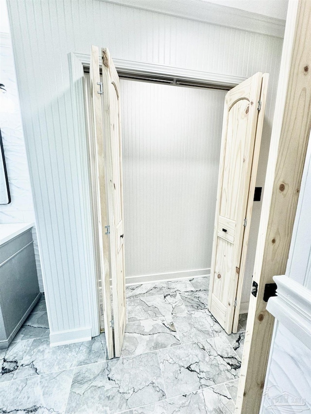 bathroom featuring wood walls and vanity