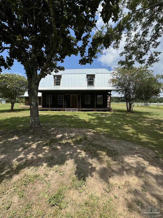 view of front of property featuring covered porch and a front yard