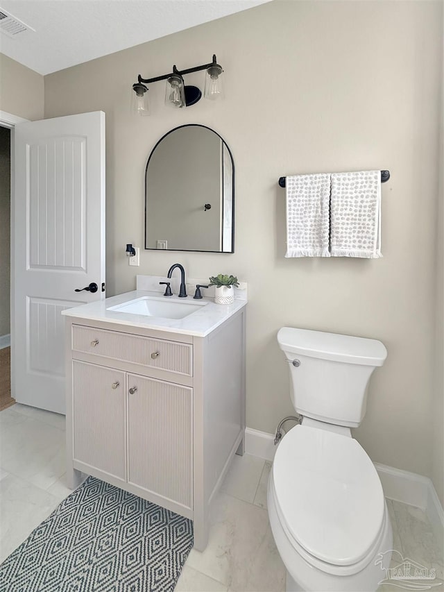 bathroom featuring vanity and toilet