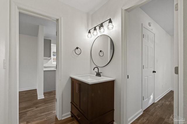 bathroom with vanity and hardwood / wood-style flooring