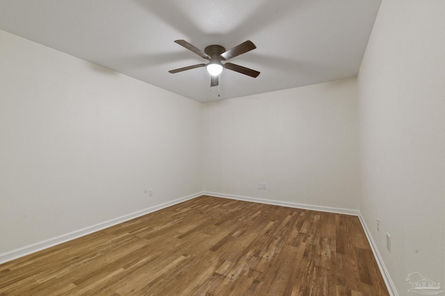 empty room with hardwood / wood-style floors and ceiling fan