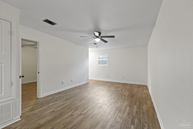 empty room featuring ceiling fan and dark wood-type flooring