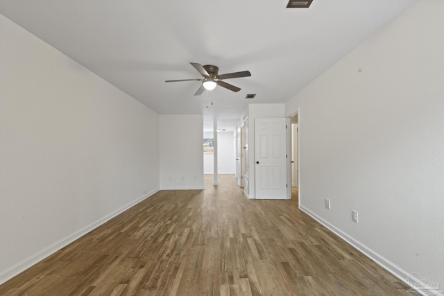 spare room with hardwood / wood-style flooring and ceiling fan