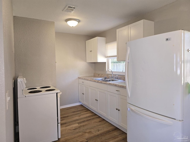 kitchen with sink, white cabinets, dark hardwood / wood-style floors, and white appliances