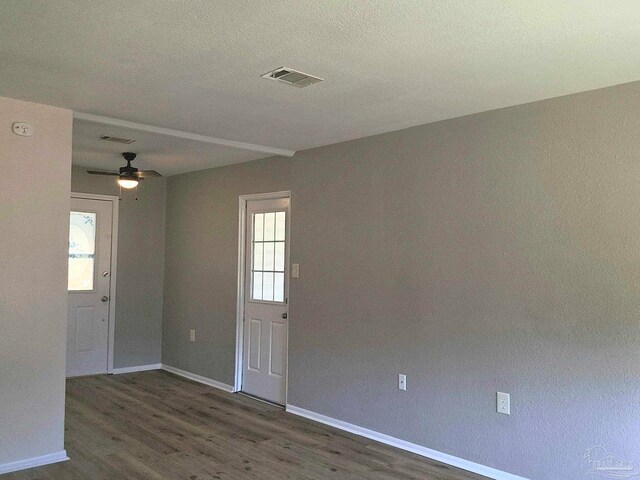 spare room with dark hardwood / wood-style floors and ceiling fan