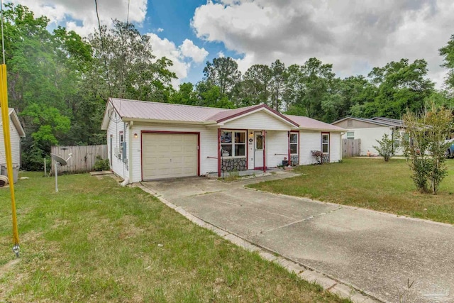 7035 Moore Ave, Pensacola, FL 32526 - ranch-style home featuring a garage, fence, metal roof, a front yard, and driveway