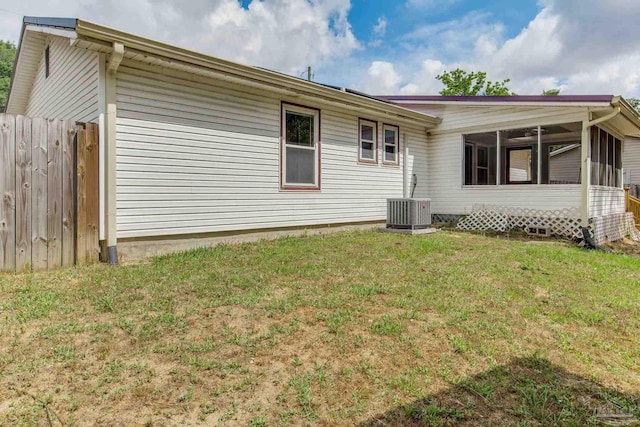 7035 Moore Ave, Pensacola, FL 32526 - rear view of house with a lawn, central AC, a sunroom, and fence