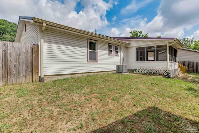 7035 Moore Ave, Pensacola, FL 32526 - back of property featuring a lawn, central AC, a sunroom, and fence