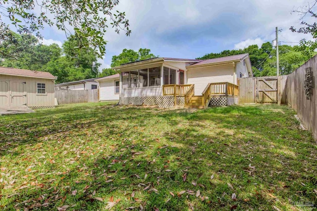 7035 Moore Ave, Pensacola, FL 32526 - rear view of property with a sunroom, a yard, a gate, and a fenced backyard