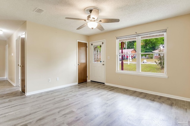 7035 Moore Ave, Pensacola, FL 32526 - empty room with wood finished floors, a textured ceiling, visible vents, baseboards, and ceiling fan