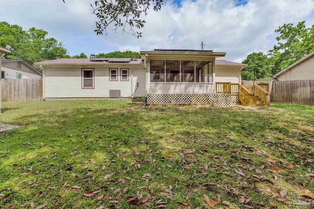 7035 Moore Ave, Pensacola, FL 32526 - back of property featuring a yard, solar panels, central air condition unit, a sunroom, and a fenced backyard