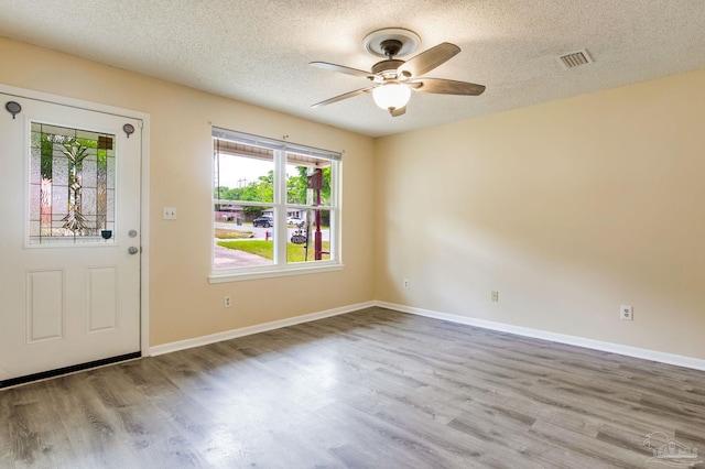 7035 Moore Ave, Pensacola, FL 32526 - entrance foyer featuring a textured ceiling, baseboards, a ceiling fan, and wood finished floors