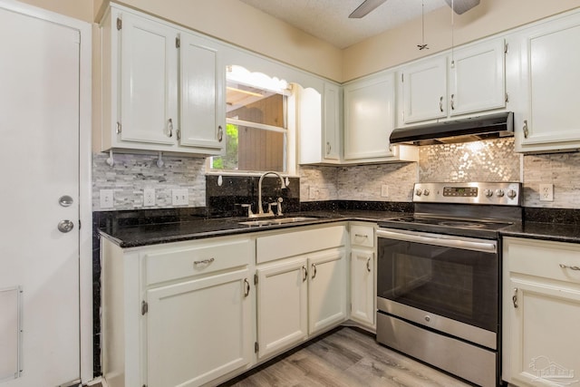 7035 Moore Ave, Pensacola, FL 32526 - kitchen with decorative backsplash, a sink, under cabinet range hood, and electric range
