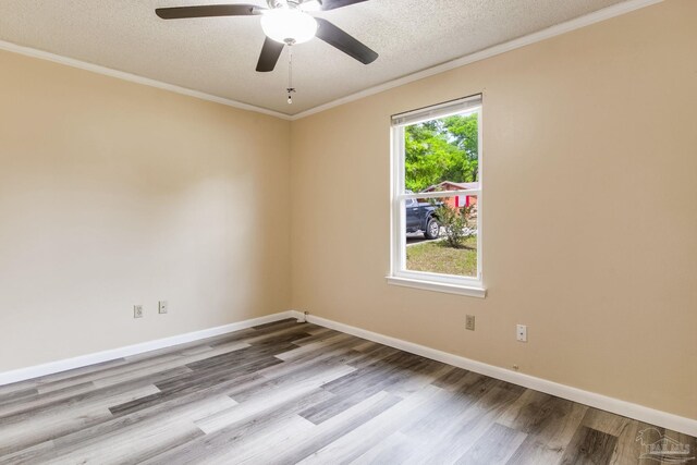7035 Moore Ave, Pensacola, FL 32526 - unfurnished room with wood finished floors, a ceiling fan, crown molding, a textured ceiling, and baseboards