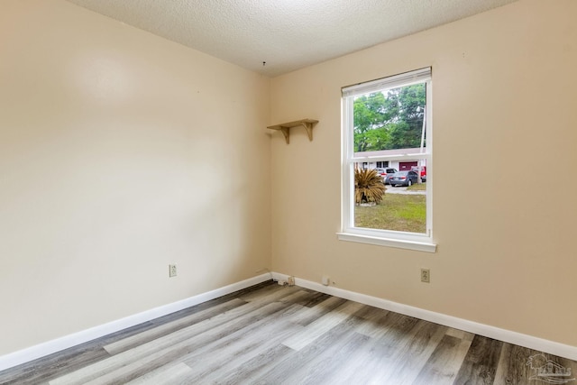 7035 Moore Ave, Pensacola, FL 32526 - unfurnished room featuring a textured ceiling, wood finished floors, and baseboards