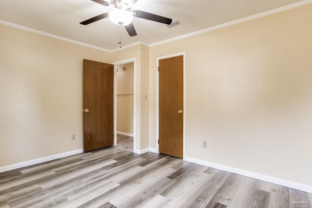 7035 Moore Ave, Pensacola, FL 32526 - unfurnished room featuring wood finished floors, a ceiling fan, a textured ceiling, visible vents, and ornamental molding