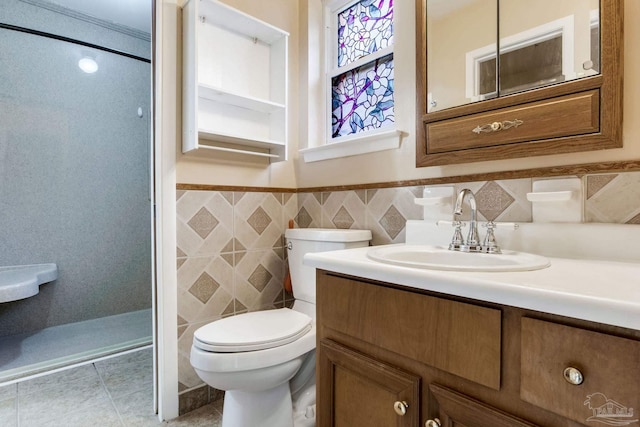 7035 Moore Ave, Pensacola, FL 32526 - full bath featuring toilet, tile patterned flooring, wainscoting, walk in shower, and vanity