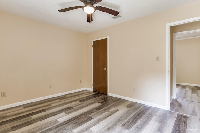 7035 Moore Ave, Pensacola, FL 32526 - unfurnished bedroom with baseboards, visible vents, a ceiling fan, and wood finished floors