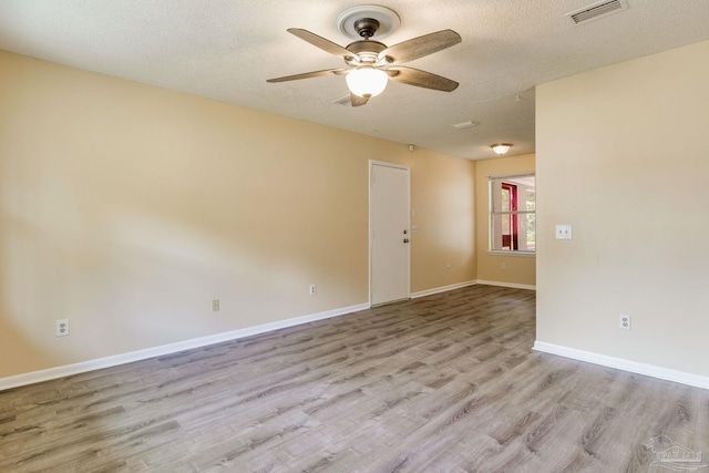7035 Moore Ave, Pensacola, FL 32526 - empty room with a textured ceiling, baseboards, light wood finished floors, ceiling fan, and visible vents