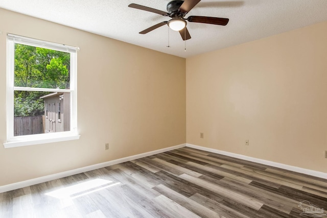 7035 Moore Ave, Pensacola, FL 32526 - empty room with ceiling fan, a textured ceiling, baseboards, and wood finished floors