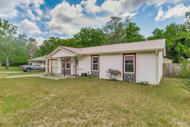7035 Moore Ave, Pensacola, FL 32526 - single story home with a front yard, driveway, fence, and a garage