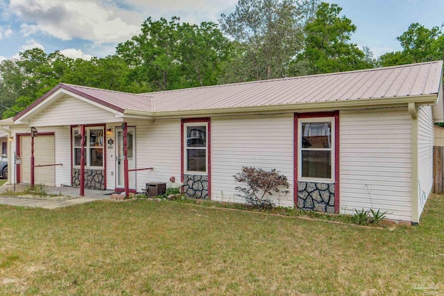 7035 Moore Ave, Pensacola, FL 32526 - single story home with a front lawn, an attached garage, and metal roof