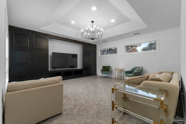 living room with a raised ceiling and an inviting chandelier