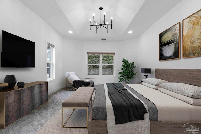 bedroom featuring a raised ceiling and a chandelier