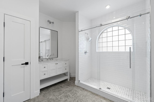 bathroom with vanity and a shower with shower door