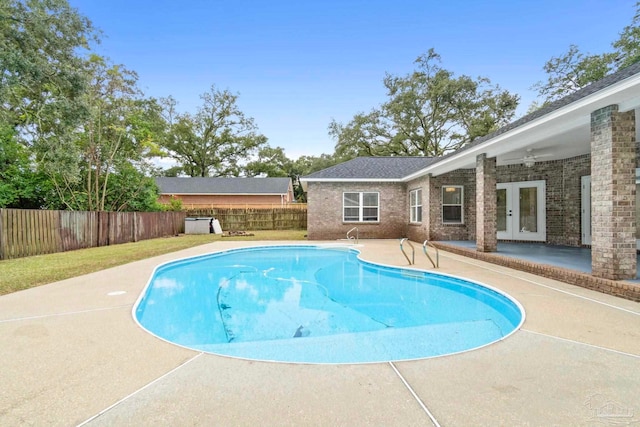 view of swimming pool with a patio area and french doors