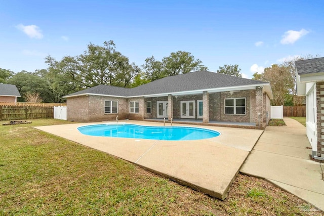 view of swimming pool featuring a lawn and a patio area