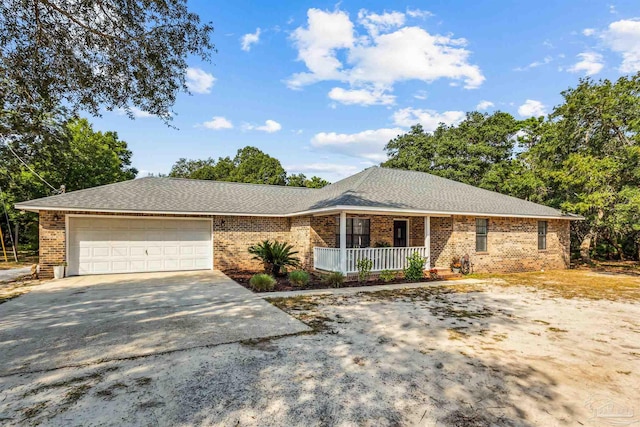 ranch-style home featuring covered porch and a garage