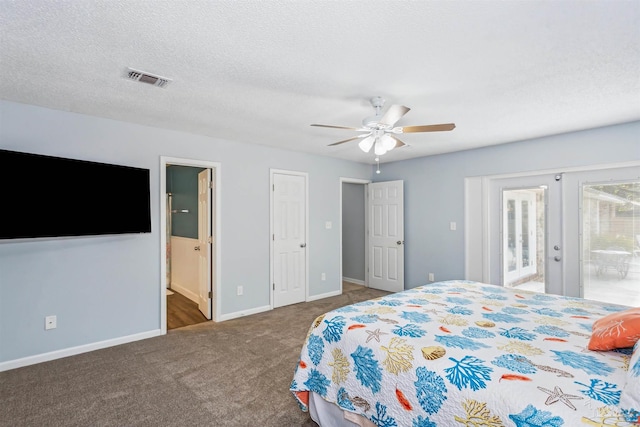 carpeted bedroom with french doors, a textured ceiling, connected bathroom, and ceiling fan