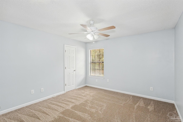 carpeted empty room featuring ceiling fan and a textured ceiling