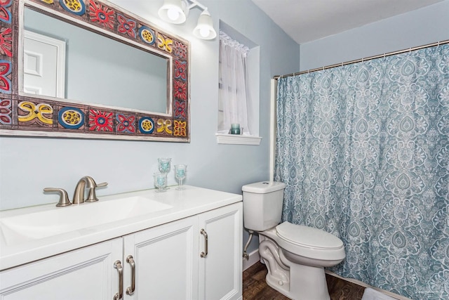 bathroom featuring vanity, toilet, walk in shower, and hardwood / wood-style floors