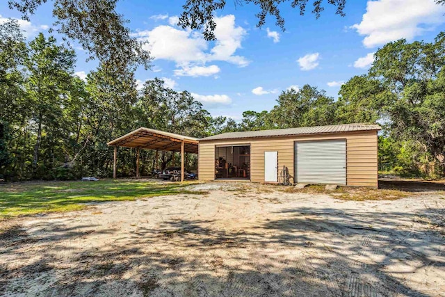 view of outbuilding with a garage and a carport