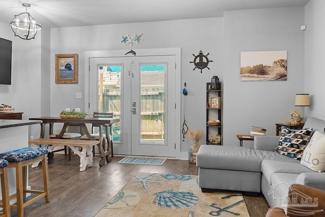 doorway to outside with an inviting chandelier and dark wood-type flooring