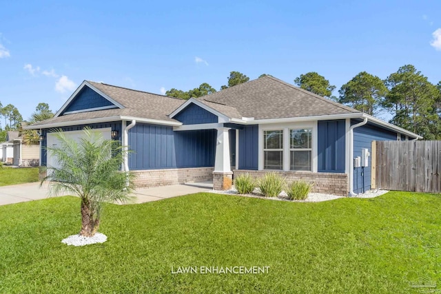 view of front of home featuring a garage and a front lawn