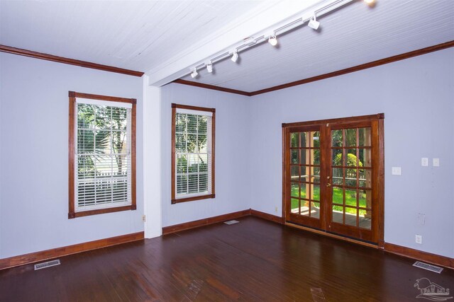 unfurnished room with crown molding, rail lighting, dark hardwood / wood-style floors, and french doors