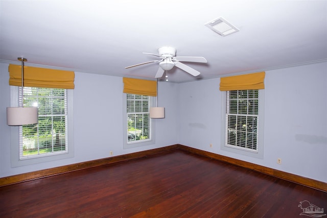 empty room featuring ornamental molding, dark hardwood / wood-style floors, and ceiling fan