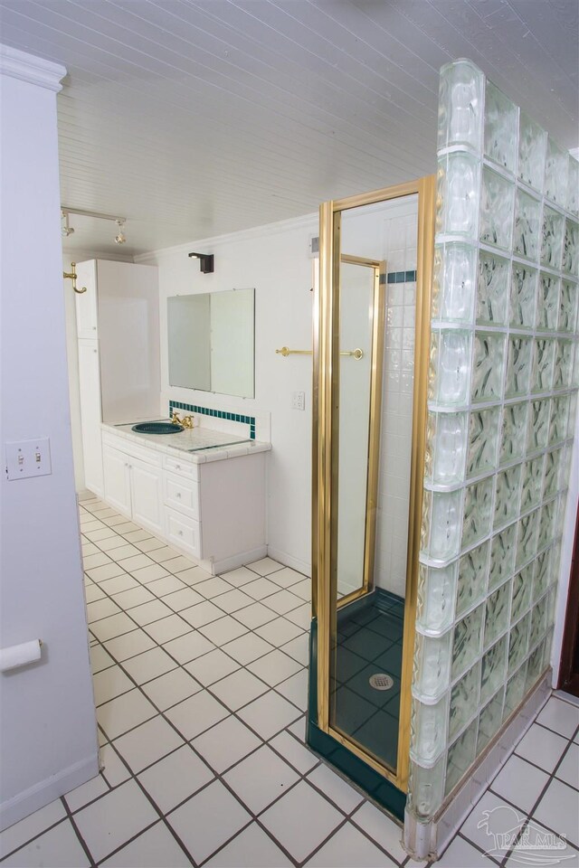 bathroom featuring vanity and a shower with door