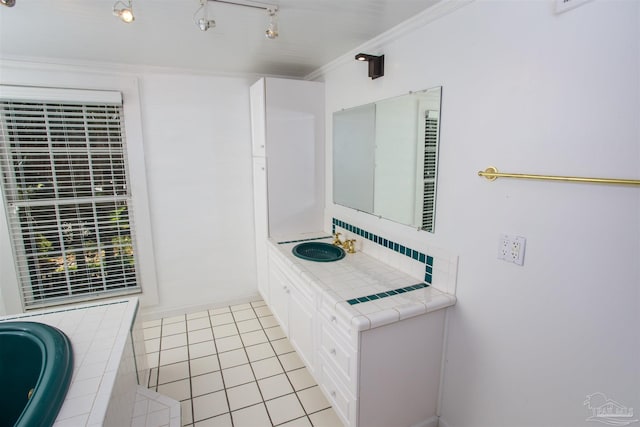 bathroom featuring crown molding, tile patterned flooring, backsplash, vanity, and track lighting