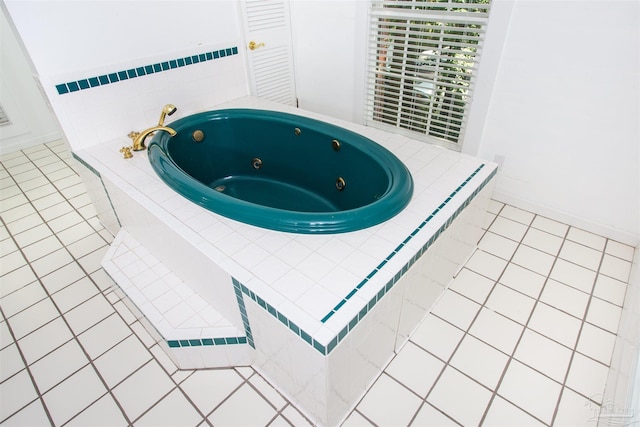 interior space with tiled bath and tile patterned flooring