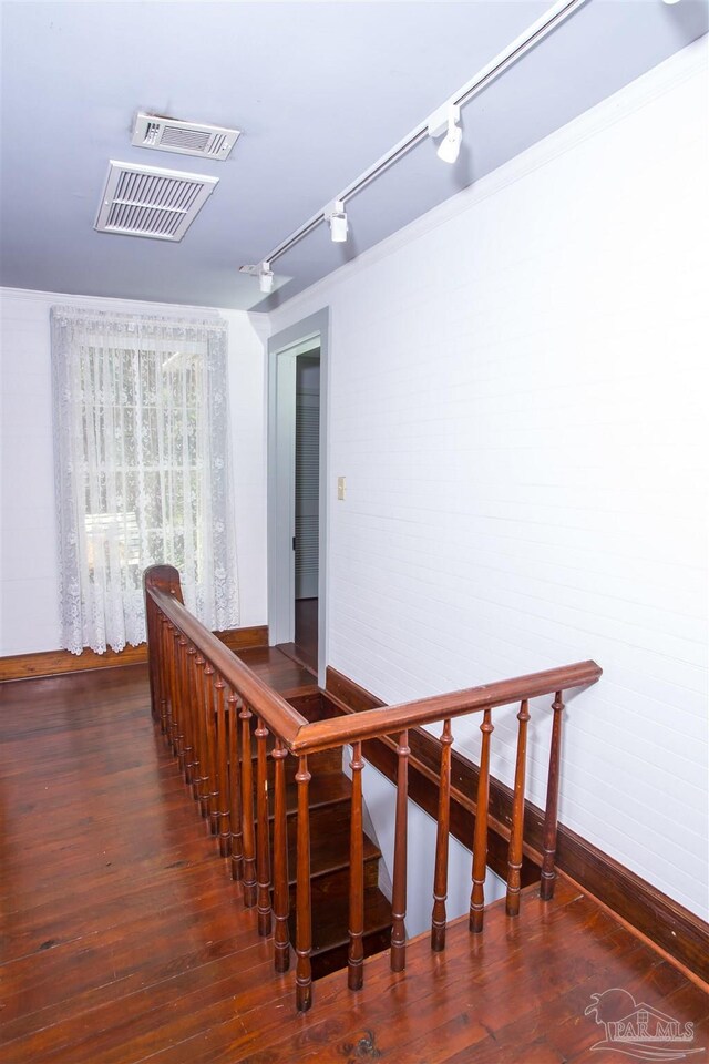 interior space with hardwood / wood-style flooring and track lighting