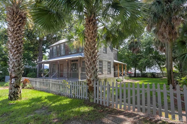 exterior space with covered porch and a front yard