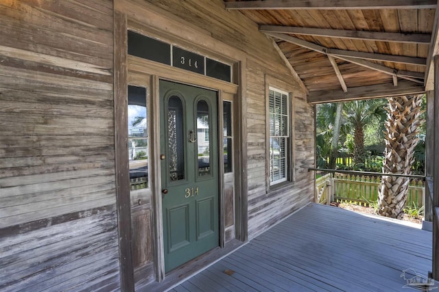 view of exterior entry with covered porch